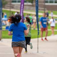 Participant nearing finish line as people watch